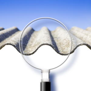 Magnifying glass against a sheet of zinc with asbestos