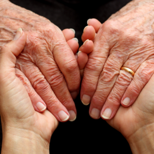 elderly person's hands in younger person's hands