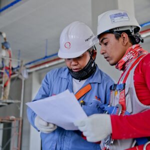 two construction workers reviewing a piece of paper