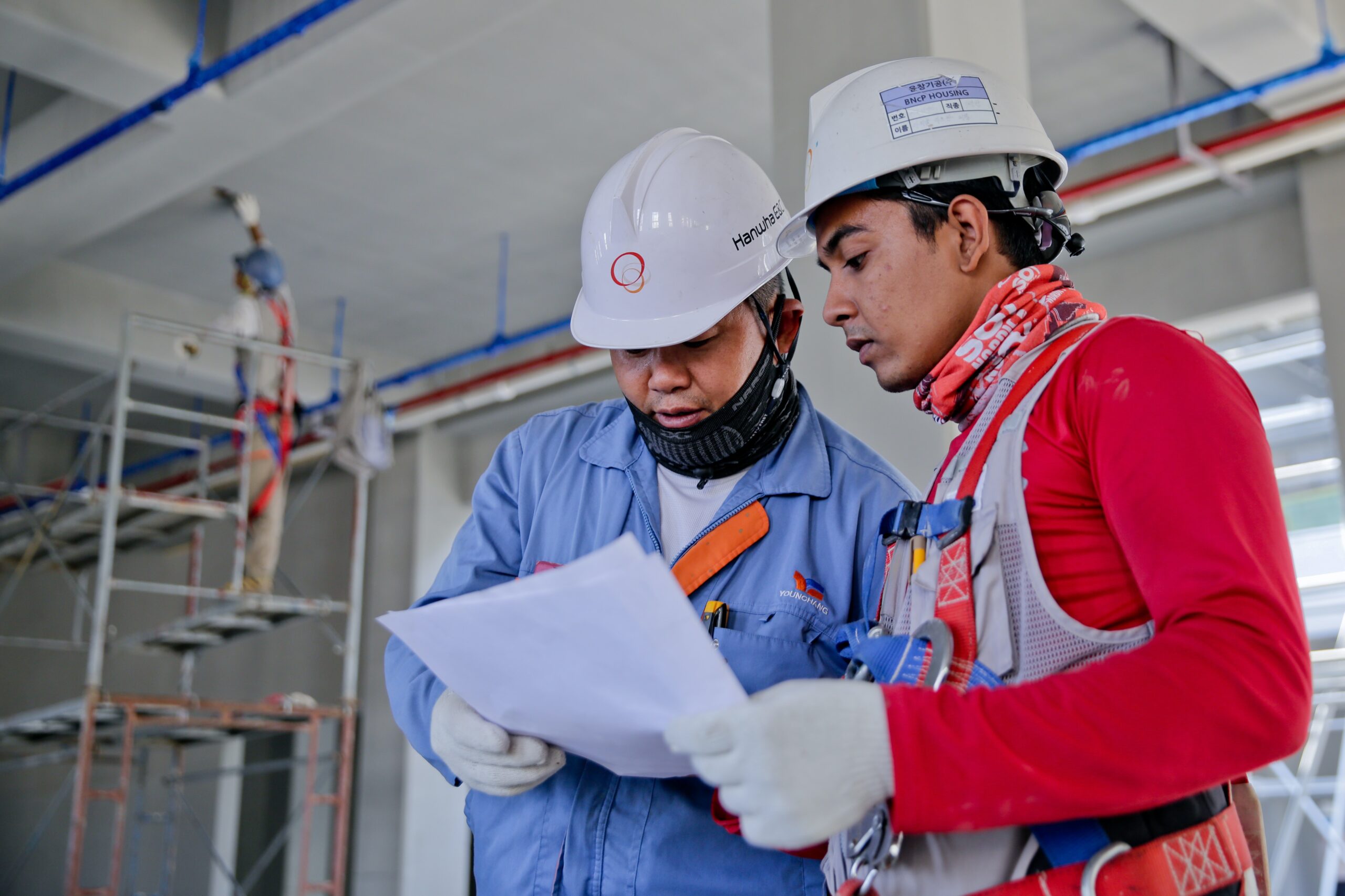 two construction workers reviewing a piece of paper