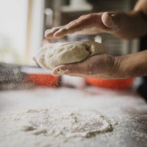 person handling dough