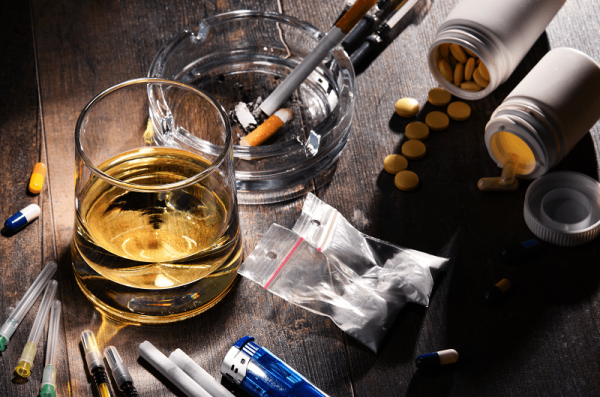 Picture of cigarettes, an alcoholic drink and some pills